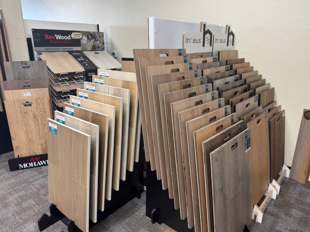 Hardwood flooring samples display with RevWood and Inhaus brands at The Flooring Store & More Tucson showroom